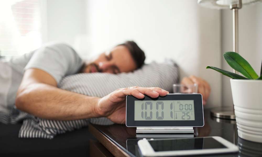 Man Turn off Alarm on Digital Clock